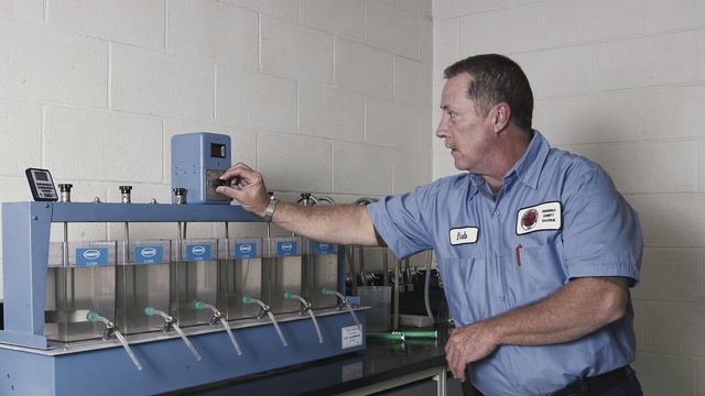 A water operator conducting a jar test